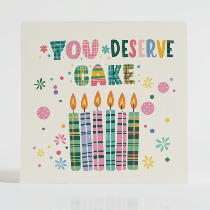 You Deserve Cake - Celebration card featuring a unique tartan design and message reflecting joy.