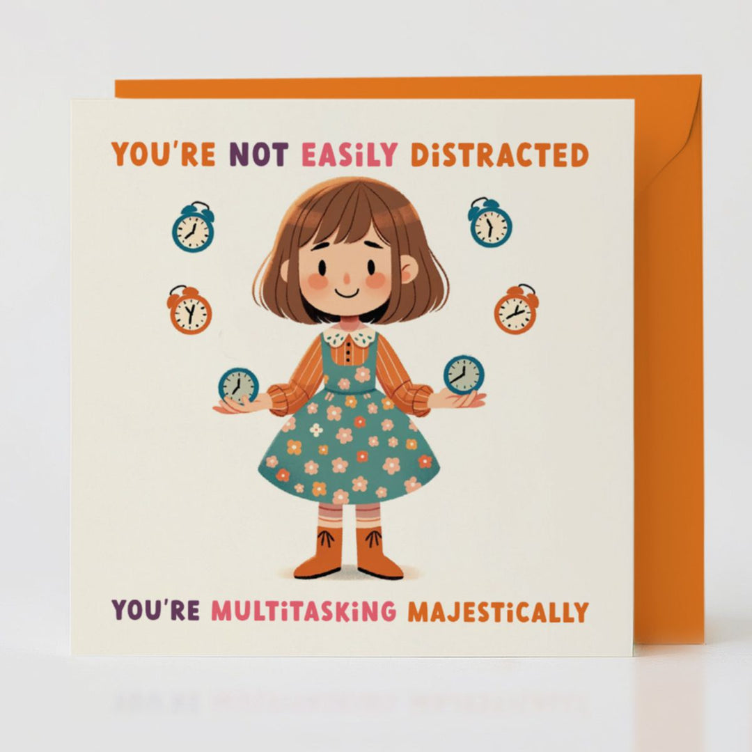 Multitasking Majestically card with orange envelope, celebrating everyday magic.