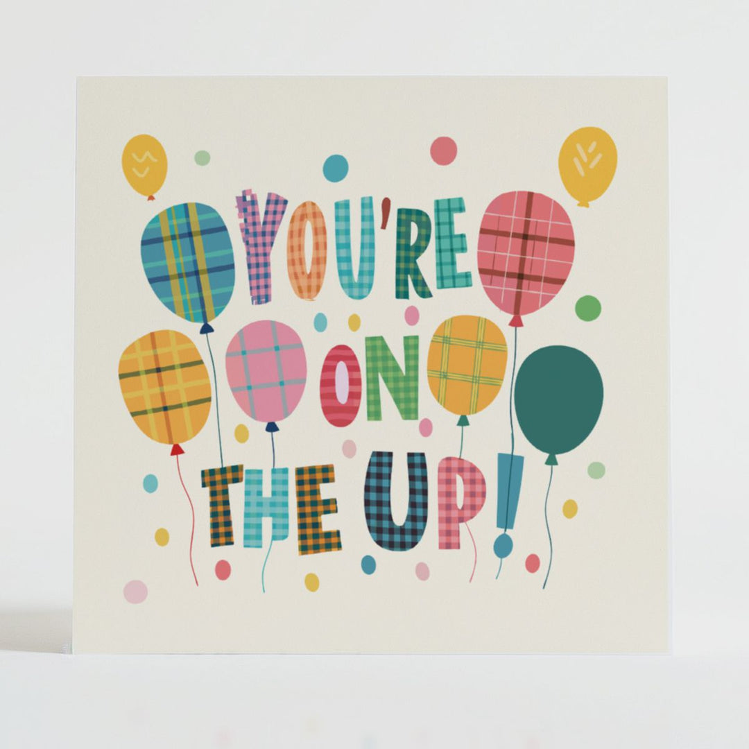You're on the Up! - Encouragement card featuring playful balloons with tartan prints and a positive message of success.
