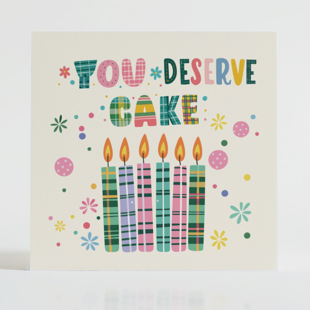 You Deserve Cake - Celebration card featuring a unique tartan design and message reflecting joy.